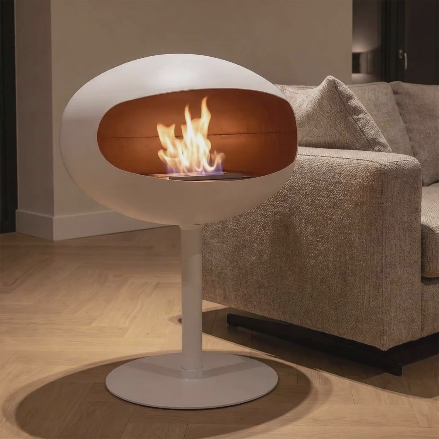 Video: Cocoon Fires Pedestal in Weiß mit brennender Flamme neben einem Sofa – Raumvisualisierung
